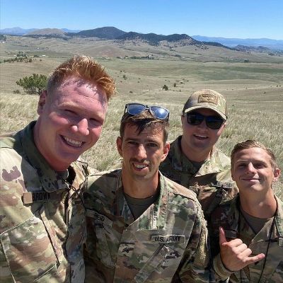 Paedon is taking a selfie with his three friends. All of them are in a military uniform.